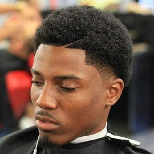 Thick afro fade haircut with a goatee