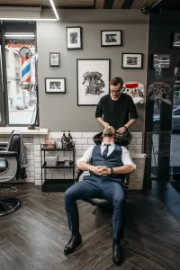 a man sitting in a chair in a barber shop