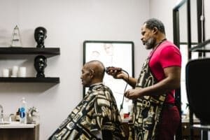 barber shaving a mans head