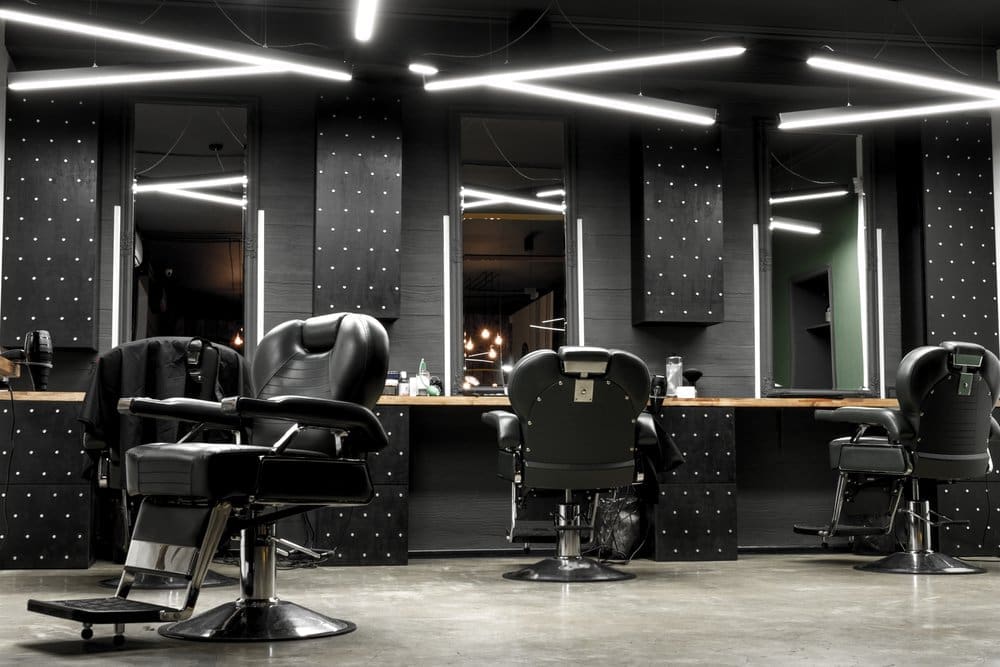 a room with chairs and mirrors